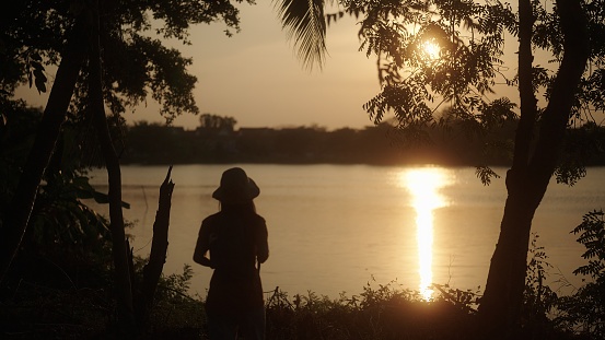 In silhouette solo traveling in nature.