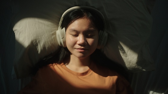 Portrait of girl listening to relax sound in the morning.