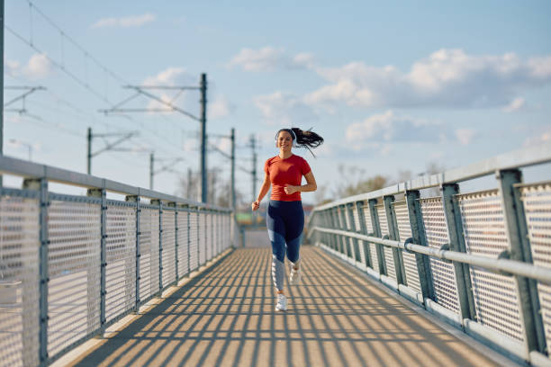 istock Happy athletic woman running while exercising outdoors. 2067786941