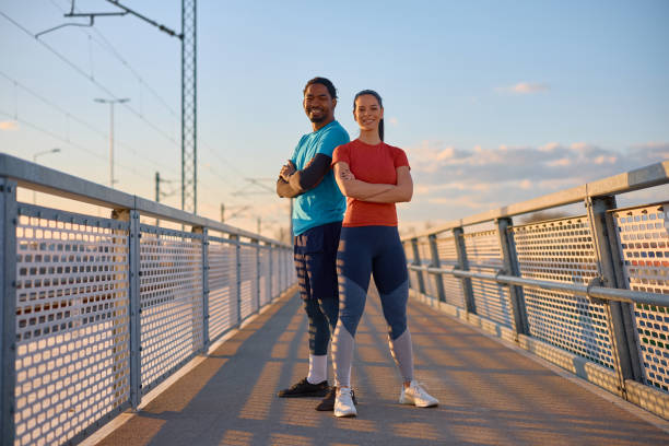 istock Confident athletic couple outdoors at sunset looking at camera. 2067797007