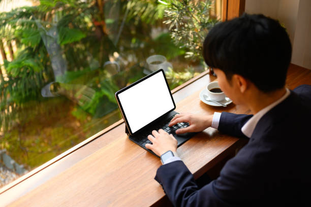 istock Above view of young businessman using digital tablet on wooden table in comfortable workplace 2067802611