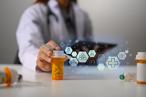 Doctor holding pills bottle in hand with medical icons. Pharmaceutical and health care concept.