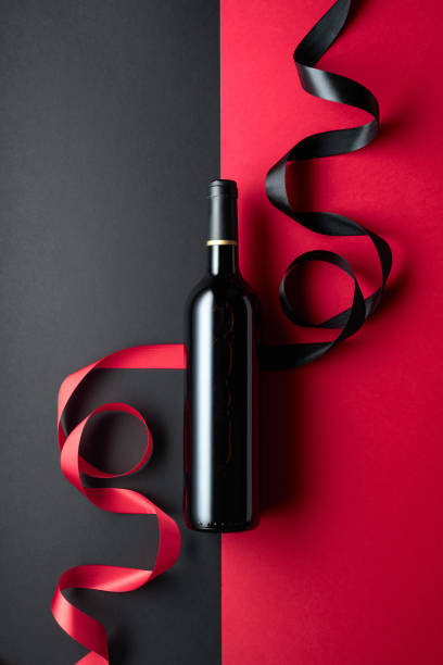 istock Bottle of red wine with satin ribbons. 2067811705