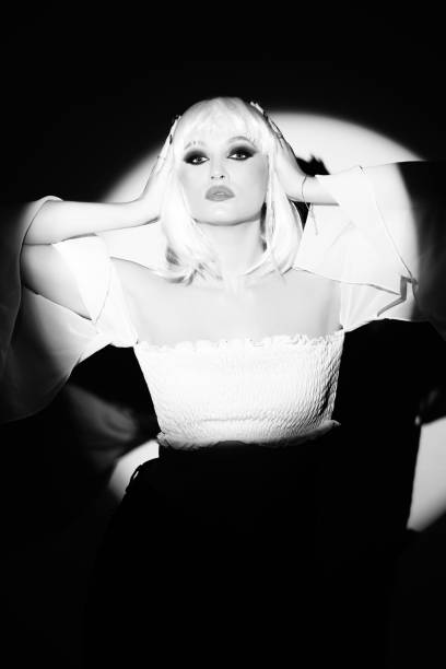 istock Beautiful woman with white wig portrait illuminated with bright round studio light 2067816560