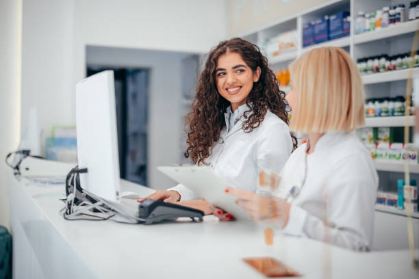 istock Two Female Pharmacist Talking in Pharmacy Drugstore 2067819753