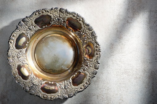 Close up of a empty silver platter on a kitchen table