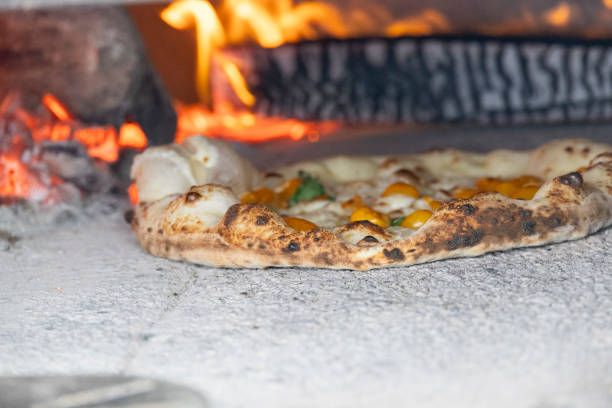 istock interior of a wood-fired oven with pizza cooking 2067856751