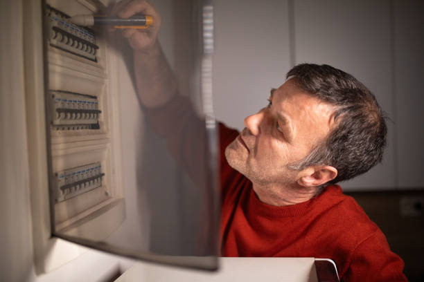 istock Man checking the fusebox in his apartment 2067857820