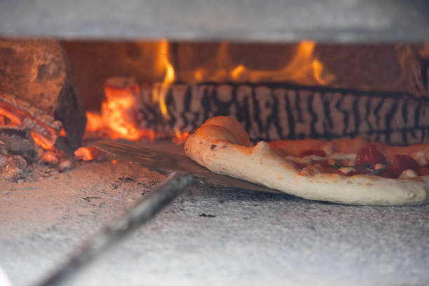 istock interior of a wood-fired oven with pizza cooking 2067857833