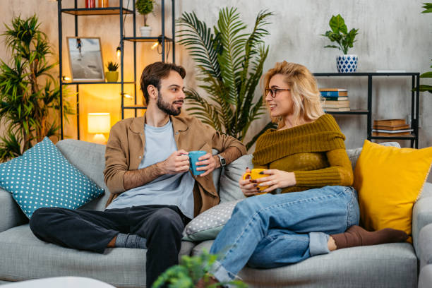 istock Young Couple Drinking Coffee And Talking On The Sofa 2067880906