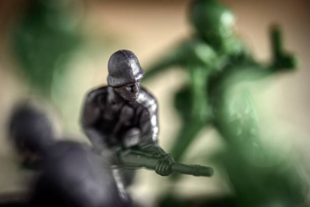 Toy soldier fighting in battle, sugar and coffee used to simulate snow, soil and explosions