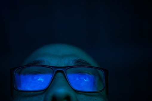 Reflection of monitor light in a man