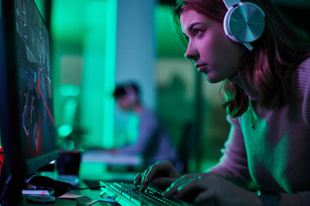 istock Focused woman playing a video game on desktop PC. 2067929533