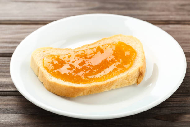 istock Toast with apricot jam in plate on wooden table 2067962241
