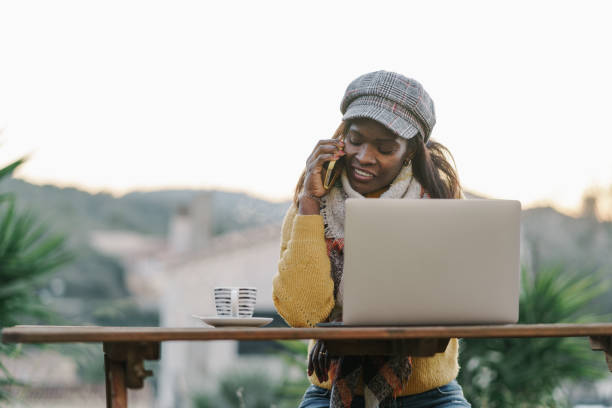 istock Ethnic freelancer speaking on smartphone in back yard 2067971952