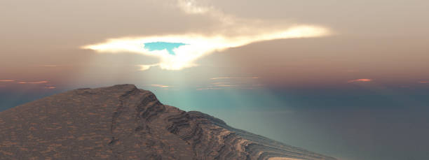 istock Gap in the clouds with sunbeams over a coastal landscape 2067973512