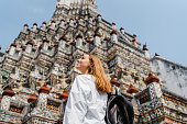 Young Woman Enjoying The View Of Wat Arun (The Temple Of Dawn) In Bangkok In Thailand