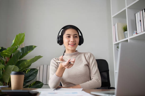 istock Young Asian student studies online about graphs and statistics. Happy Zoom video call studying with laptop computer 2068004017