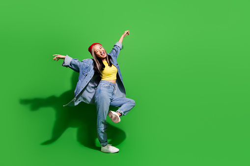 Full length photo of adorable pretty lady wear denim jacket having disco fun empty space isolated green color background.