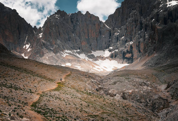 istock Tourist on a winding path in the snowy mountains 2068063488