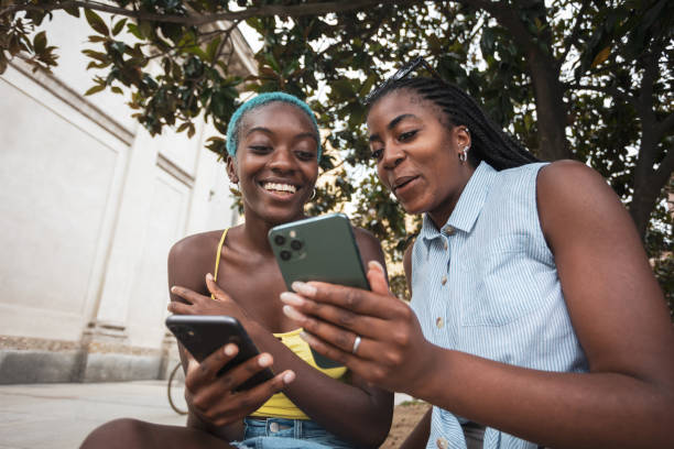 istock Two African friends using mobile phone 2068093332