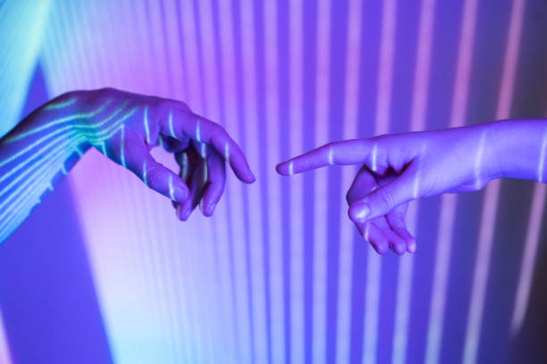 istock Colorful touching hands covered in abstract lights 2068100644