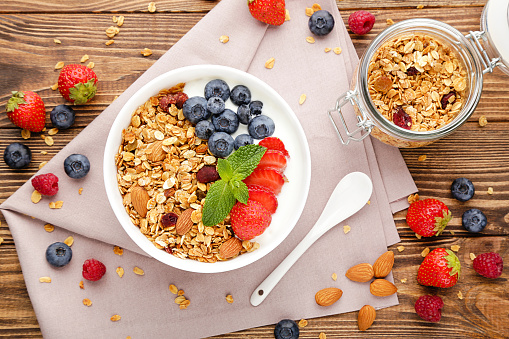 Delicious and healthy breakfast containing various fruits and oat meal cereal