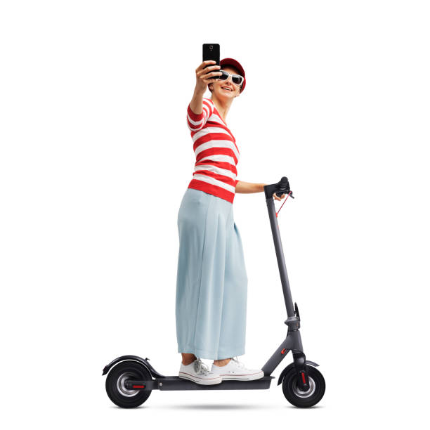 istock Woman using her smartphone and riding an e-scooter 2068126345