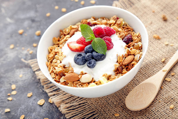 istock Tasty granola with fresh berries on grey background 2068131994
