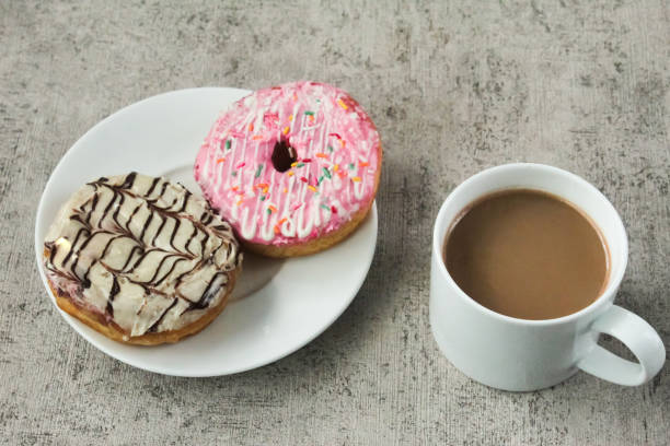 istock a plate of donuts and a cup of coffee 2068146112