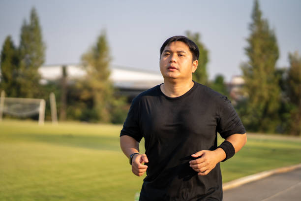 istock Fat man jogging to lose weight in the park 2068150537