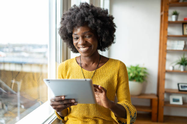 istock Young business woman reading emails on her digital tablet 2068187621