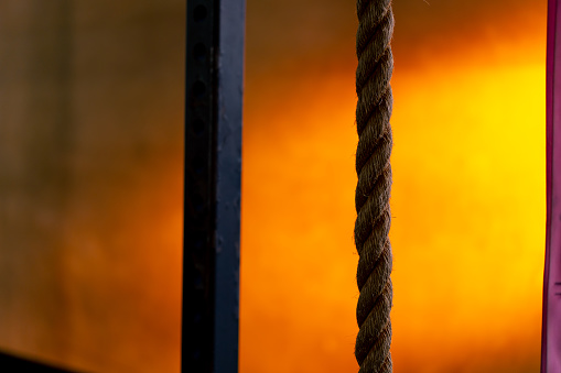 close-up of ropes for exercise in a sports club on a bright orange background