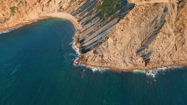 istock Beautiful sunny coastal cliffs over turquoise ocean water drone view. Sea waves 2068219714