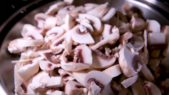 Mushrooms, fried in a pan in heated butter with onions and pepper. Mushrooms in the process of stewing and frying in a pan in butter