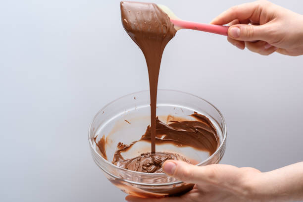 istock The process of tempering chocolate, stirring melted chocolate with a silicone kitchen spatula 2068245855