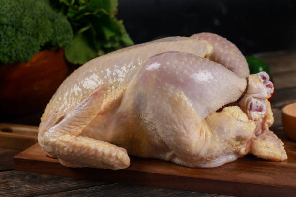 istock Raw chicken is placed on a cutting board and prepared for cooking. 2068255856