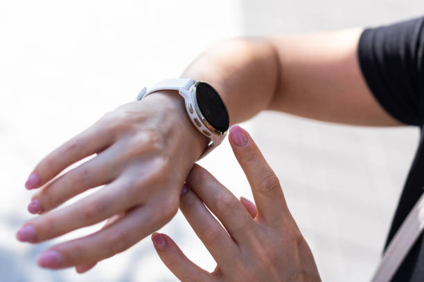 istock Modern sport gadget concept - young woman using a smartband 2068270989
