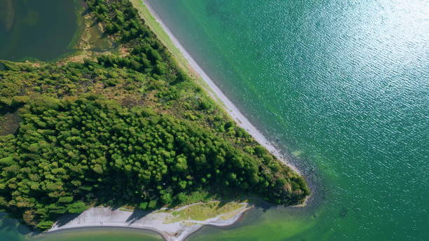 istock Stunning green island landscape drone view. Dense tree tops growing cape hills 2068276384