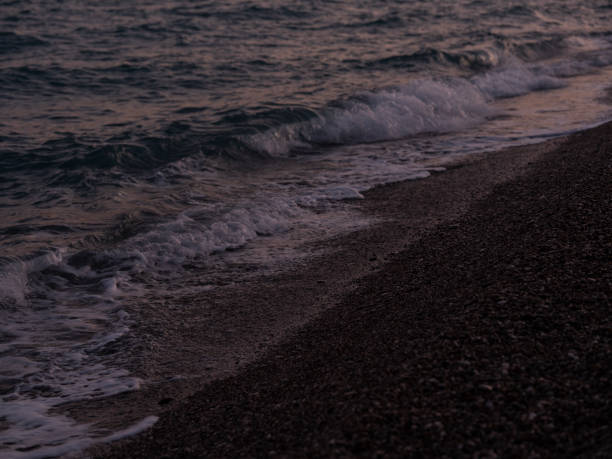 istock waves on the beach in the evening 2068279616