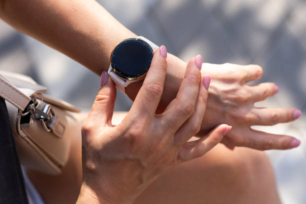Modern sport gadget concept - young woman using a smartband. High quality photo