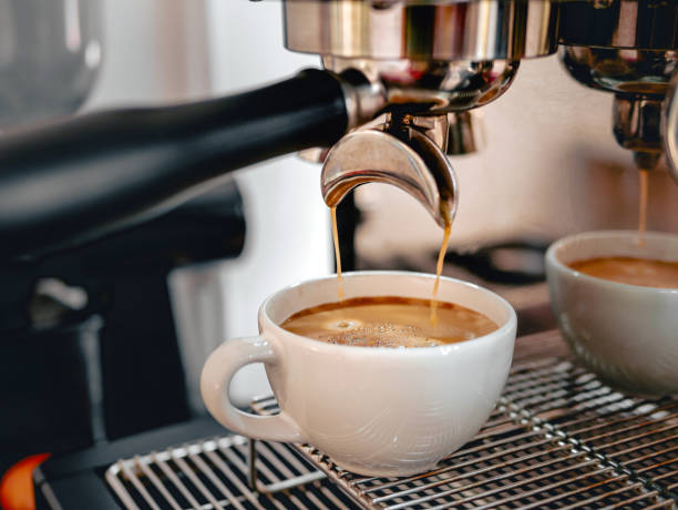 istock Coffee extraction from the coffee machine with a portafilter pouring coffee into a cup,Espresso poruing from coffee machine at coffee shop 2068285634