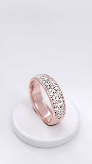 A sophisticated rose gold ring adorned with pave-set diamonds, displayed on a stand with space for text