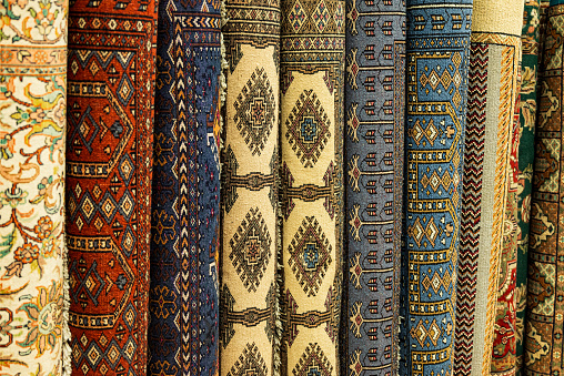 assortment of traditional hand woven Indian carpets and rugs (also known a Mighal carpets)