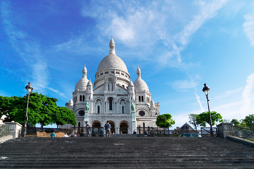 view of world famous Sacre Coeur church facade with stairs at summer, Paris, France
