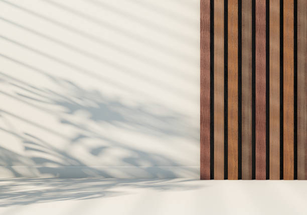 istock White background with wooden lamellas on the wall. An abstract background for presenting products in a minimalist style. Shade from blinds and plants 2068390418
