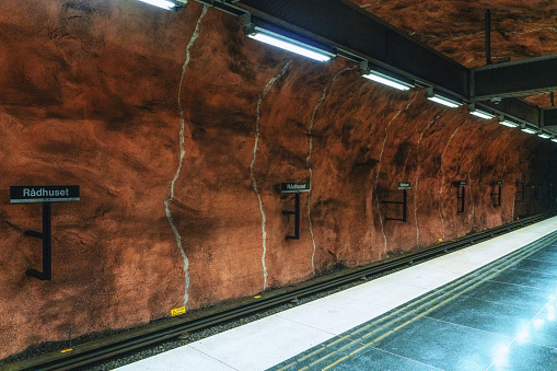 underground metro tunnelbana station Radhuse with track platform and orange brown patterned caves walls and ceiling