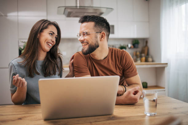 istock Adult couple using laptop computer at home. 2068437532