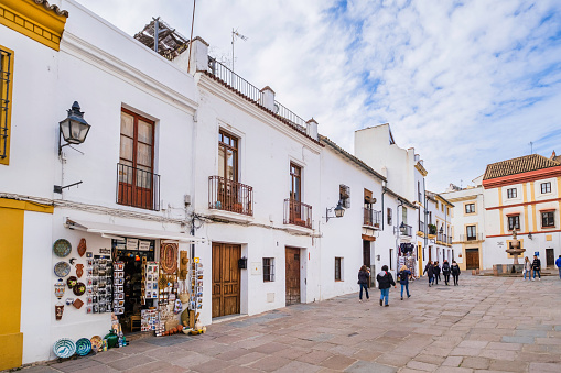 People strolling in Plaza del Potro in the old town of Cordoba, where overlook shops selling souvenirs and craft