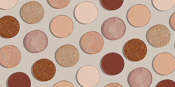 Pattern with refill eye shadow beige brown natural color on neutral colored background, banner. Makeup palette eyeshadows powder, shine and matte, minimal aesthetic photo pastel colored, top view